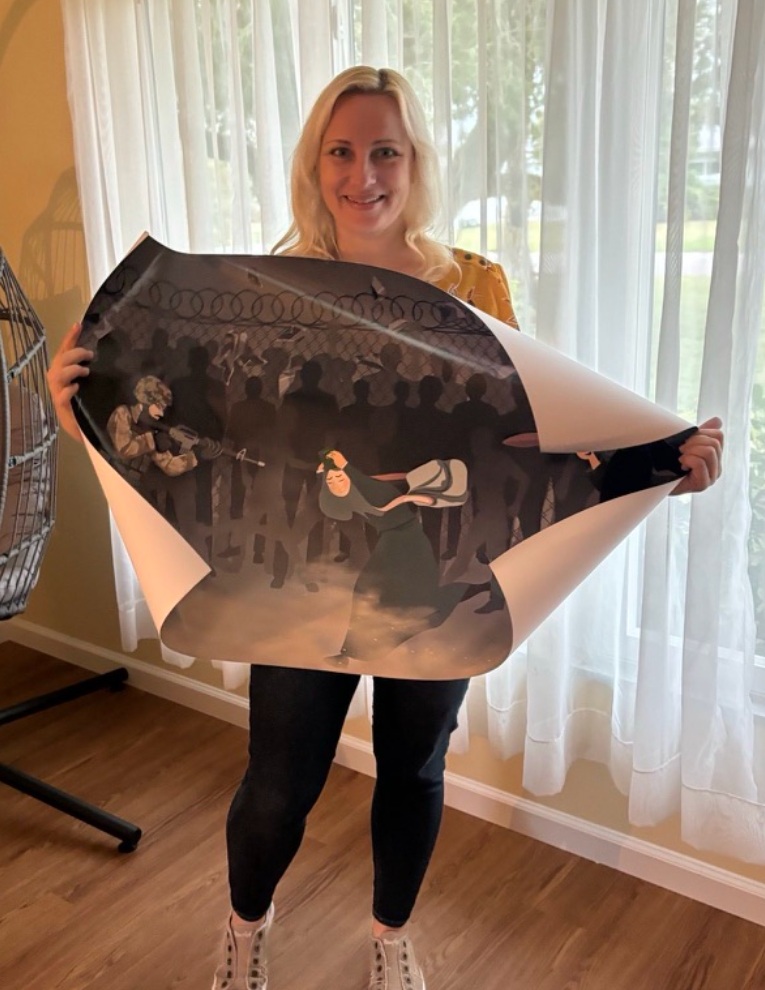 Sarah holding a work by Khatera Akbari purchased from the Art of War exhibition
