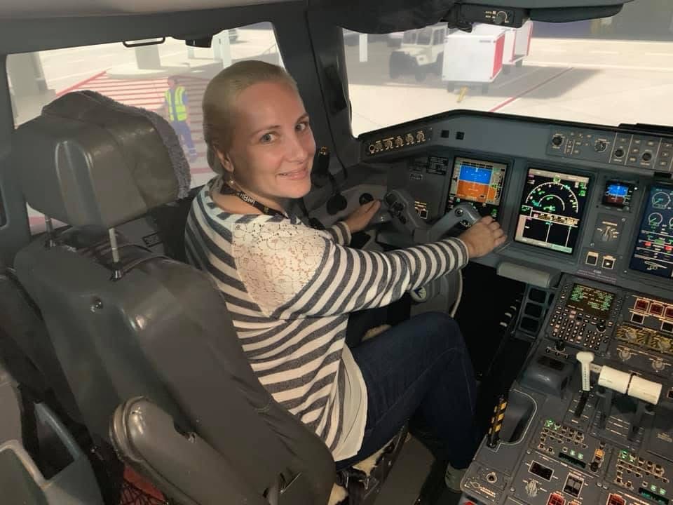 Sarah Adams exploring the cockpit of an airplane