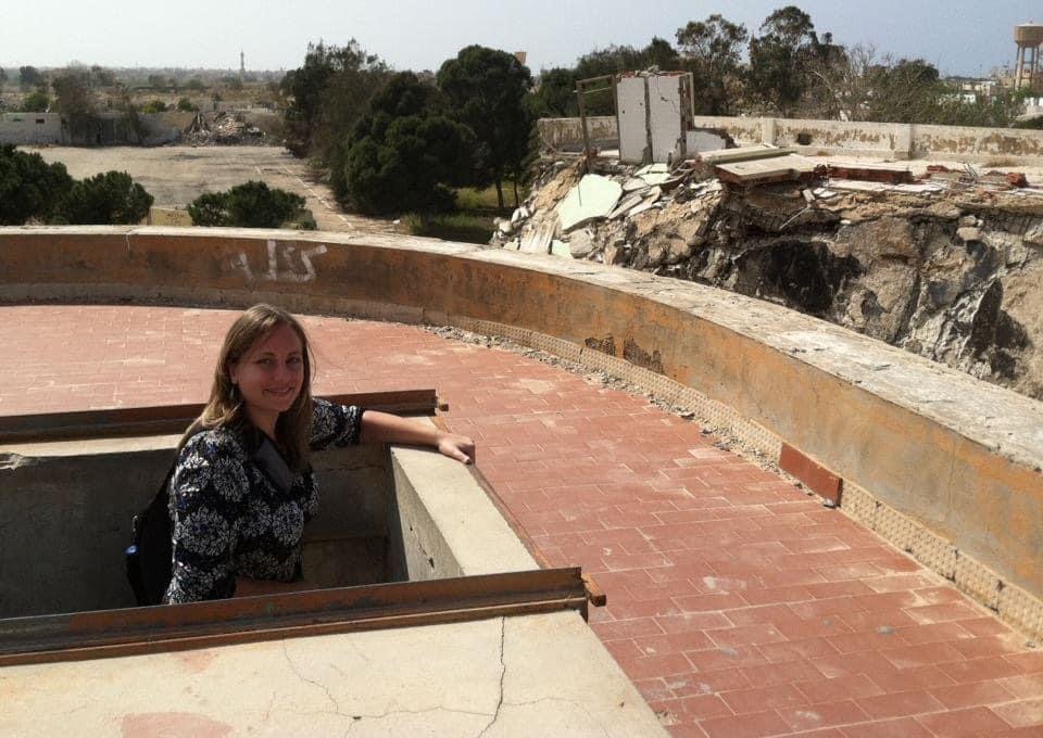 Sarah Adams observing a damaged site during field travel
